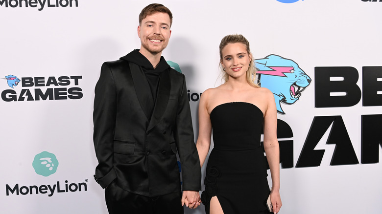 MrBeast holding hands with fiancee Thea Booysen.