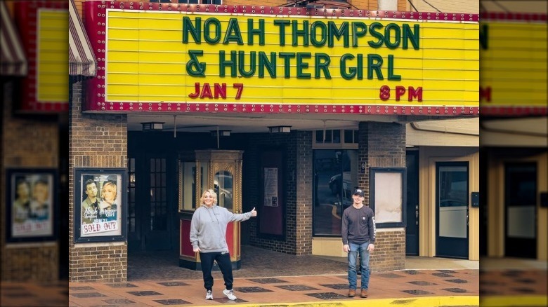 Noah Thompson, HungerGirl posing in front marquee