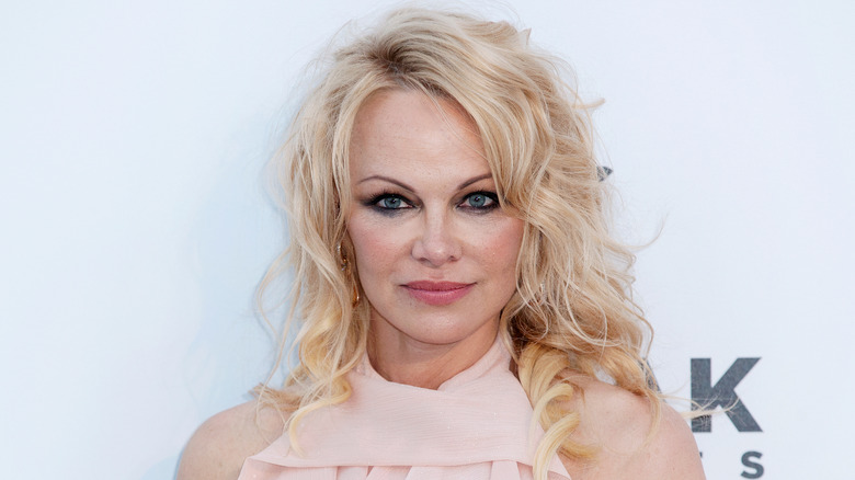 Pamela Anderson curly blond hair smiling 