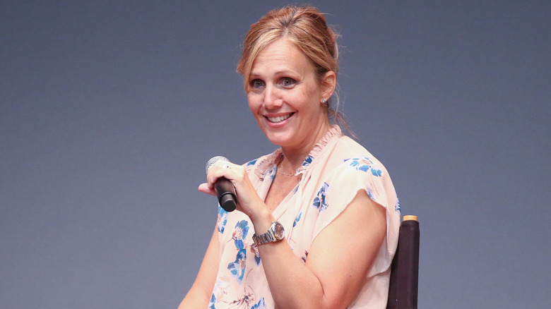 Julie Rudd holding a microphone