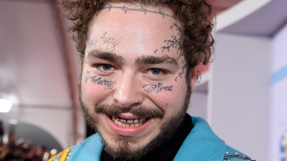 Post Malone smiling at an event 