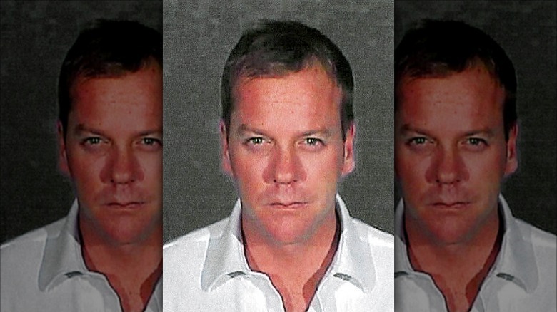 Kiefer Sutherland posing for mugshot