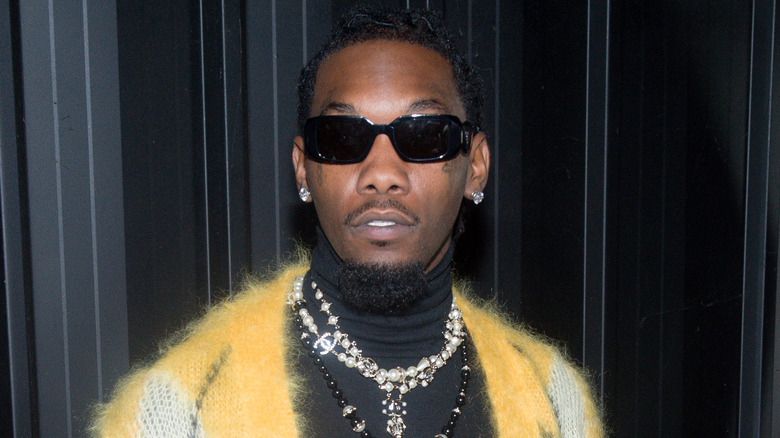 Offset wearing a yellow cardigan and pearls