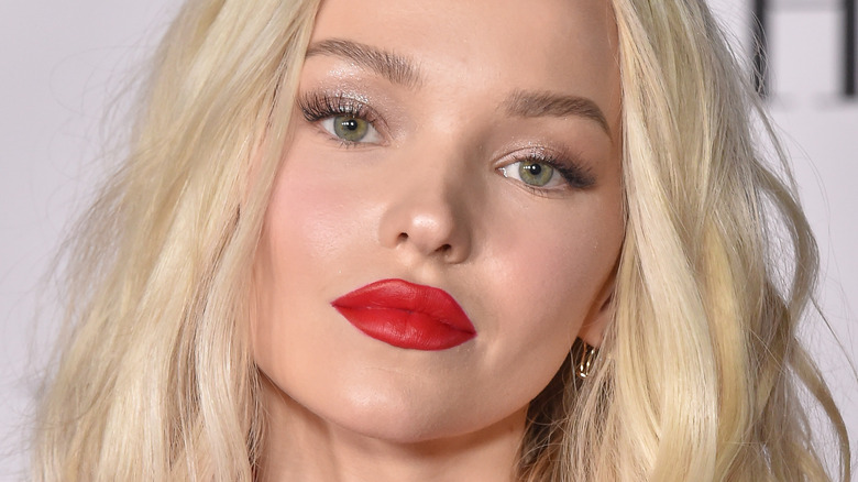 Dove Cameron wearing red lipstick with slight smile