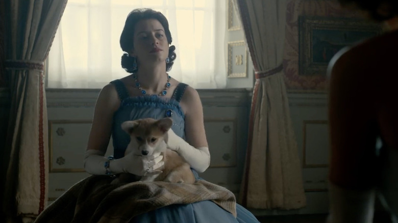 Claire Foy with corgis in a scene from The Crown