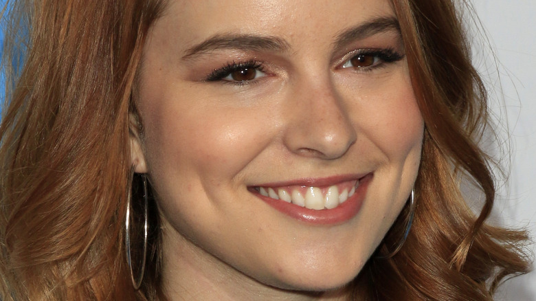 Bridgit Mendler smiles in silver hopp earrings