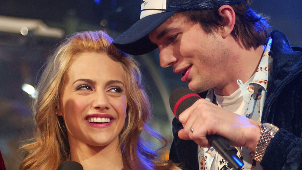 Brittany Murphy and Ashton Kutcher speaking at a New Years Eve party