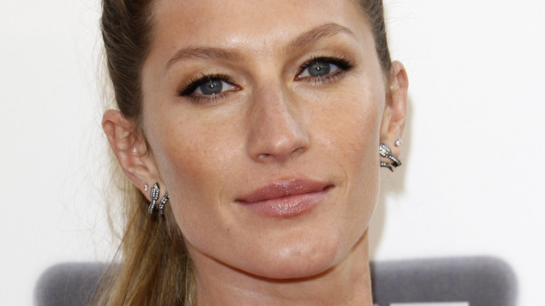 Gisele Bündchen diamond earrings smiling pink lip