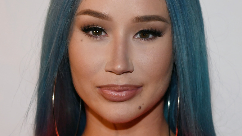 Iggy Azalea, half smiling, wearing makeup, blue hair, 2019 event