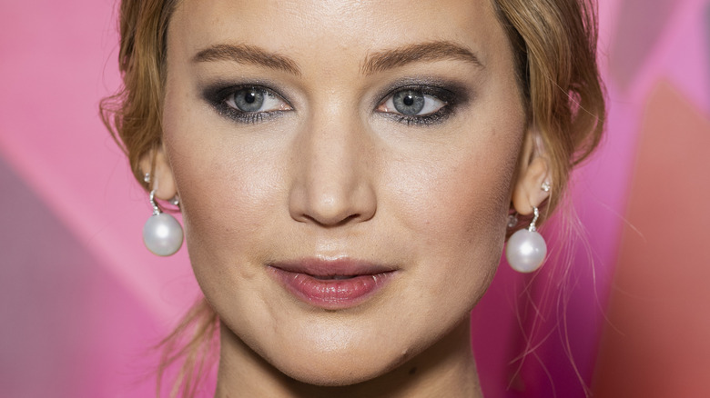 Jennifer Lawrence posing in pearl earrings