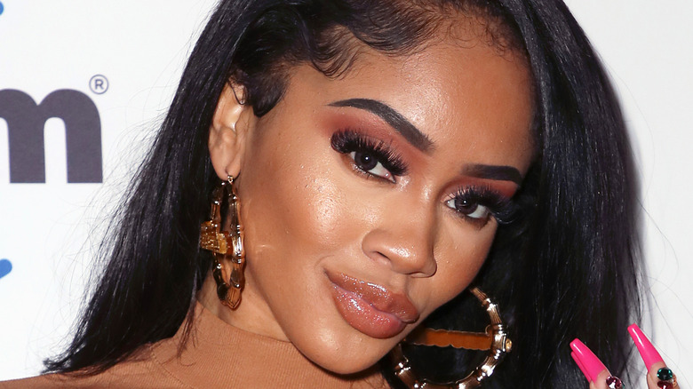 Saweetie wearing bamboo earrings