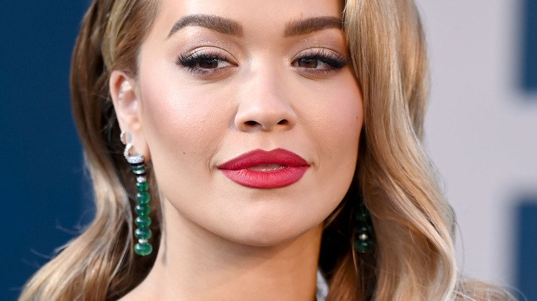 Rita Ora wearing red lipstick at an event