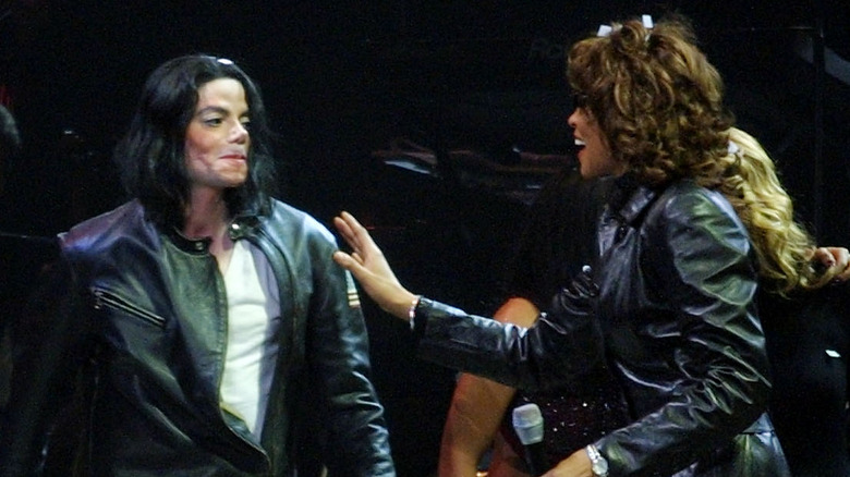 Whitney Houston and Michael Jackson laughing on stage