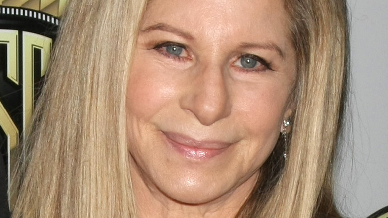 Barbra Streisand poses in a black dress.