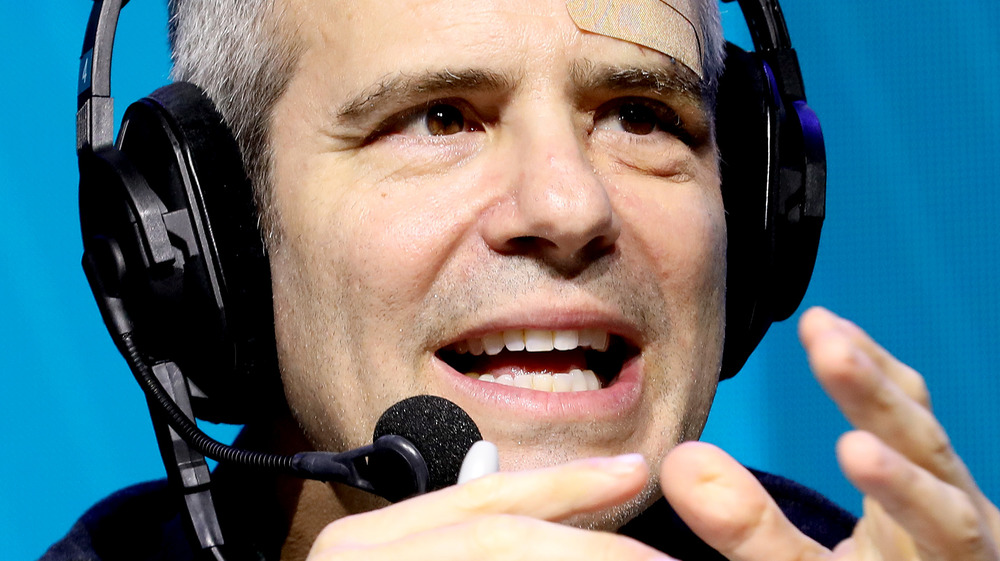 Andy Cohen speaks on stage at an event