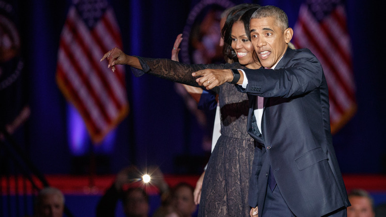 Barack and Michelle Obama pointing