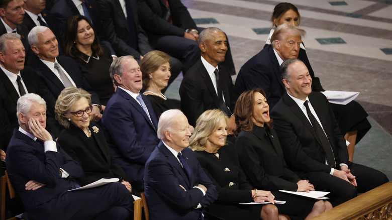 Barack Obama sits alone amid politicians and their spouses