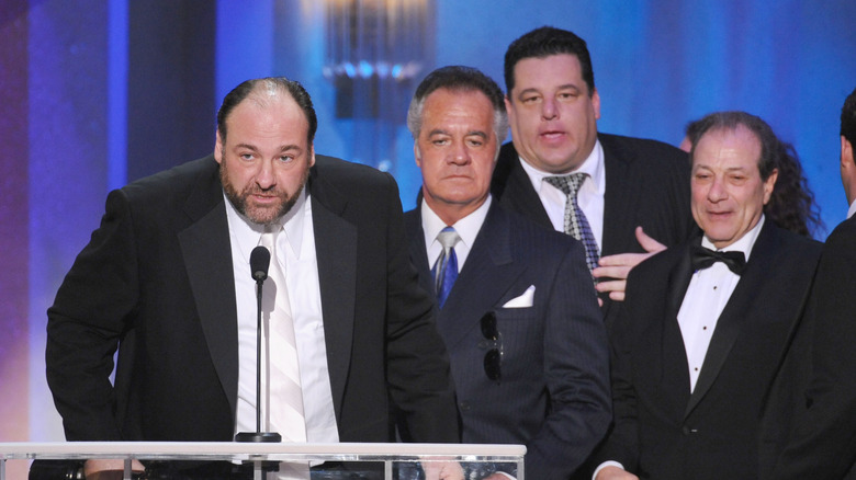 James Gandolfini at the podium with the Sopranos cast behind him.