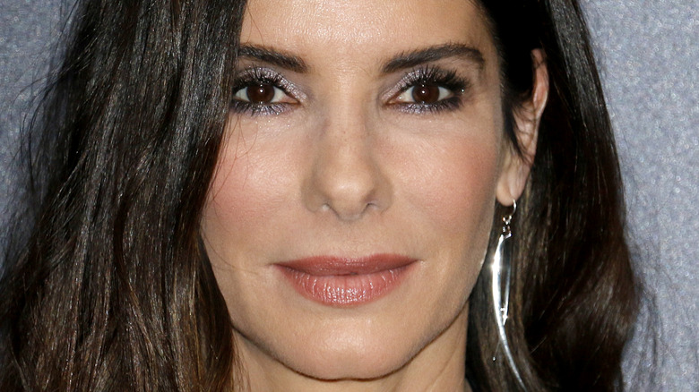 Sandra Bullock poses with silver earrings.