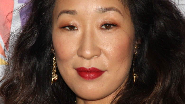Sandra Oh poses in red lipstick