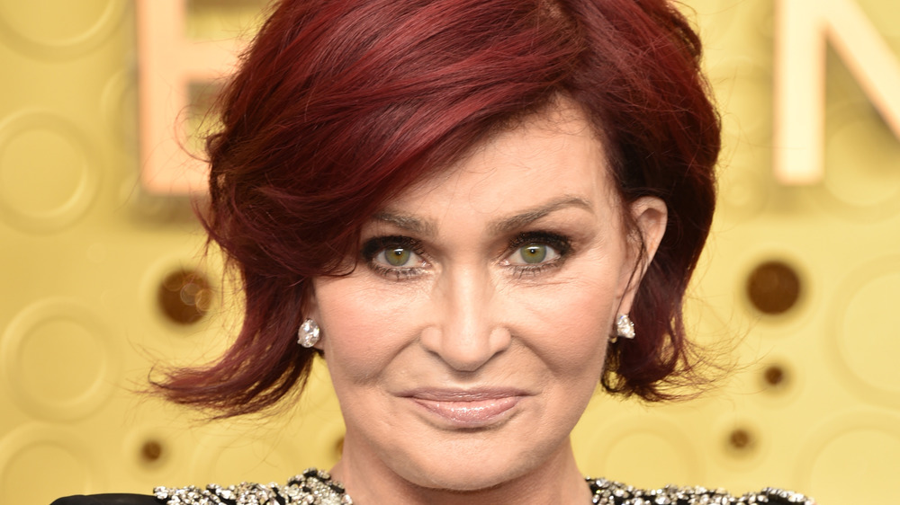 Sharon Osbourne smirking on the red carpet