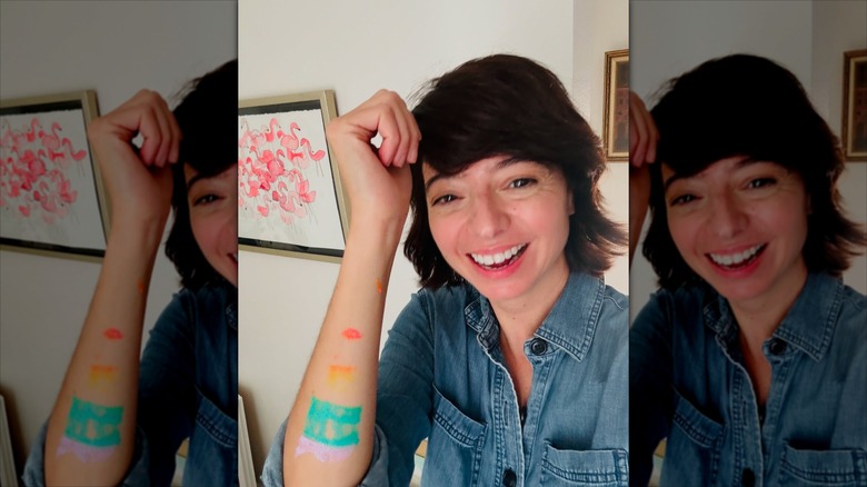 Kate Micucci smiling with paint on her arm