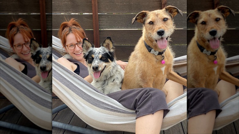 Laura smiling in a hammock with two dogs