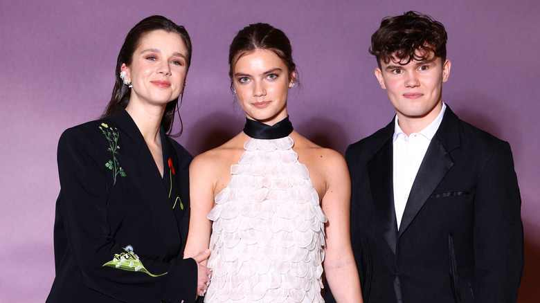 The Bridgerton cast wearing black and white formal wear on the red carpet