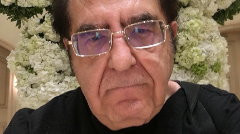 Dr. Nowzaradan in front of flowers