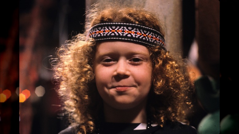 Opal (Natasha Lyonne) wears a headband