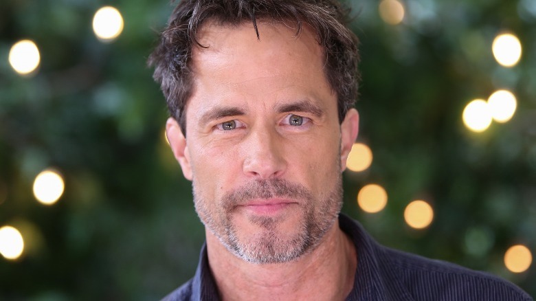 Shawn Christian posing in front of Christmas lights