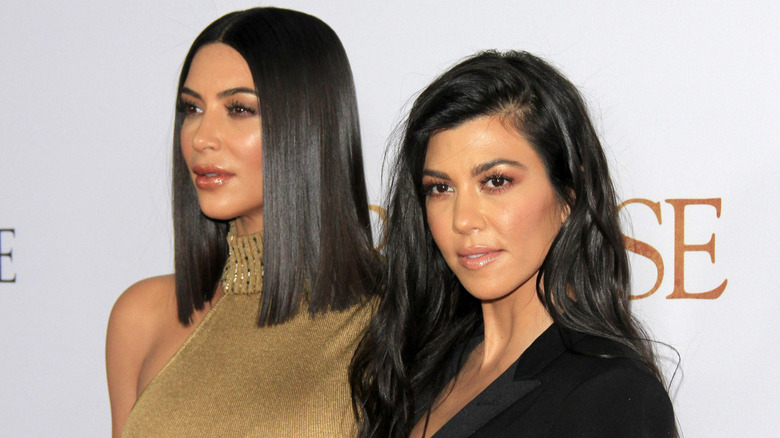 Kim and Kourtney Kardashian at an event