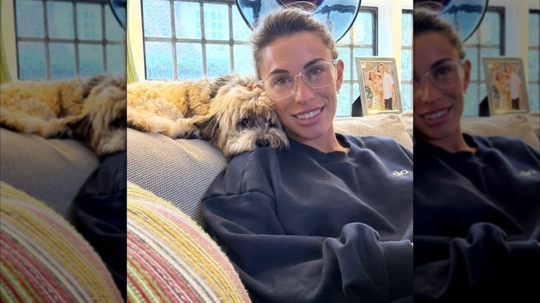 Alyssa Farah Griffin sitting on couch with dog resting its head on her shoulder