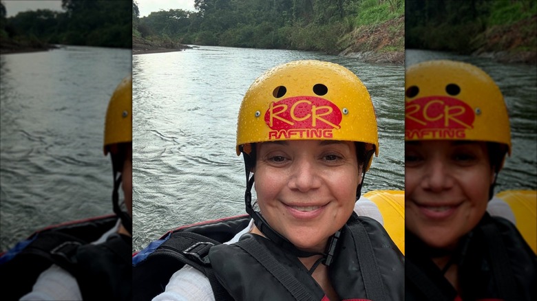 Ana Navarro wearing a helmet while rafting on a river