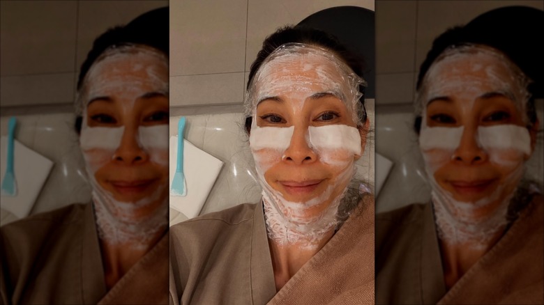 Lisa Ling wearing a face mask while lying back at a spa
