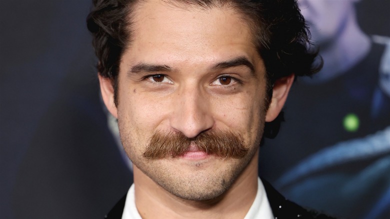 Tyler Posey mustache teen wolf movie premiere, looking at camera