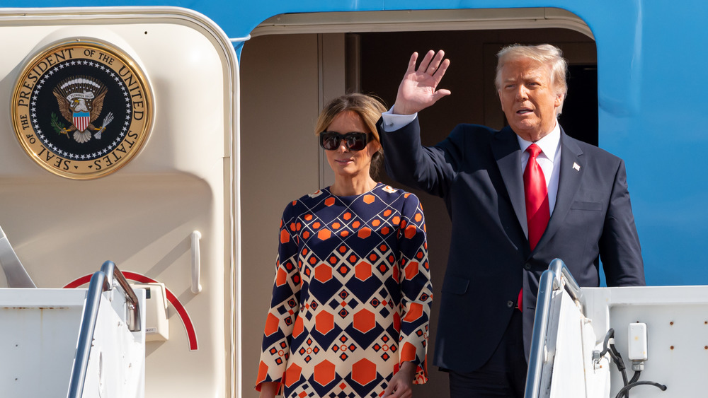 Melania and Donald Trump deplaning  