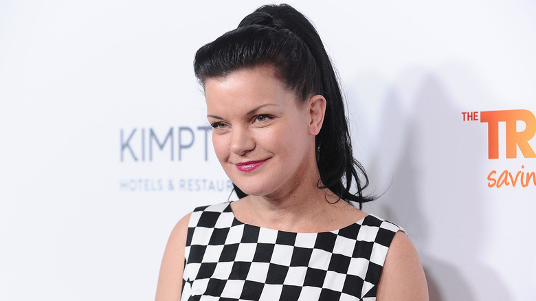 Pauley Perrette wearing checked dress at event