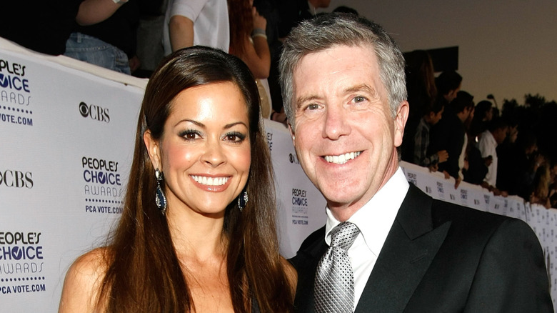Brooke Burke smiling with longtime Dancing With the Stars host Tom Bergeron.