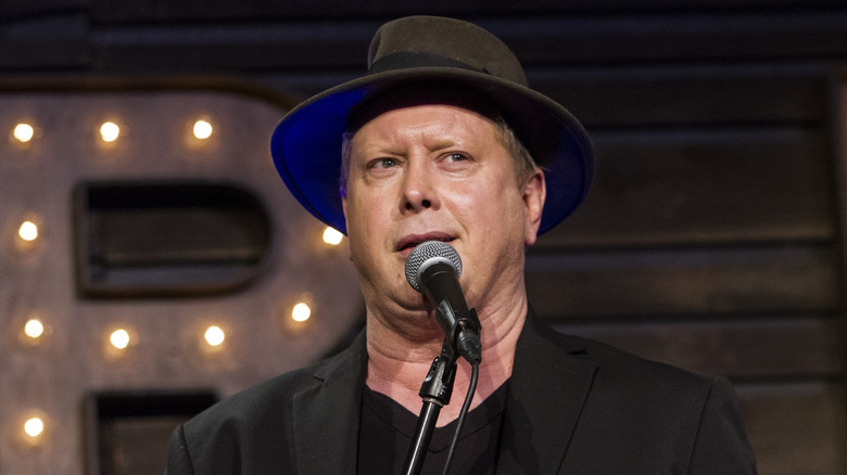 Darrell Hammond talking into a mic