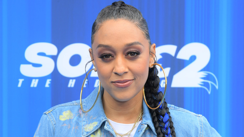 Tia Mowry poses in hoop earrings