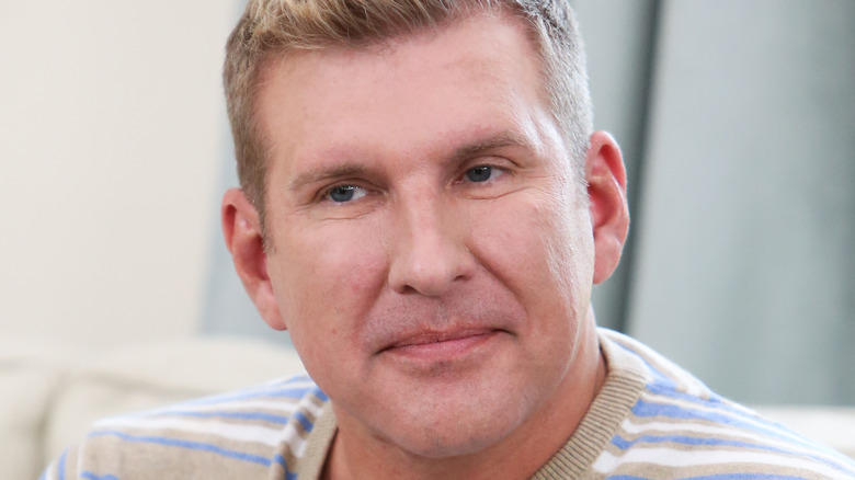 Todd Chrisley, 2018 photo, looking upset, no facial hair, not smiling