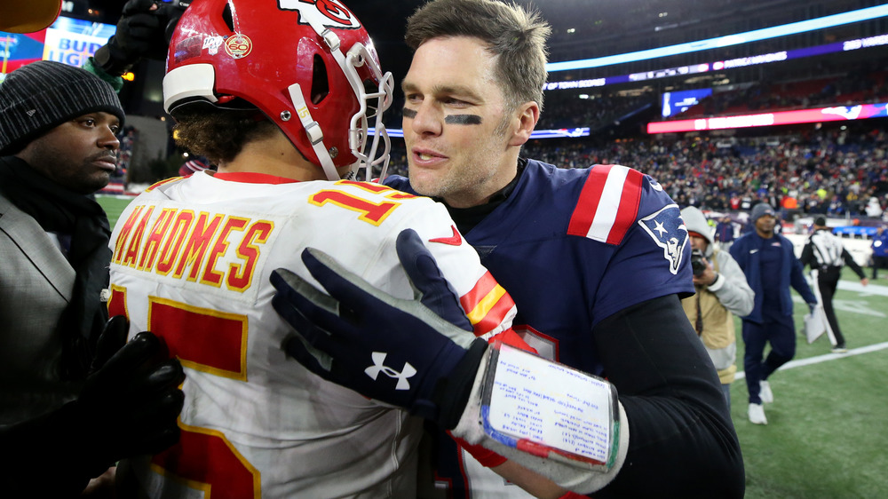 Tom Brady hugs Patrick Mahomes after a game in 2019