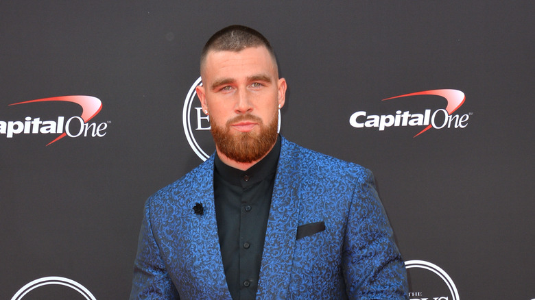 Travis Kelce, posing at an event