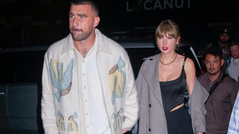 Travis Kelce and Taylor Swift holding hands
