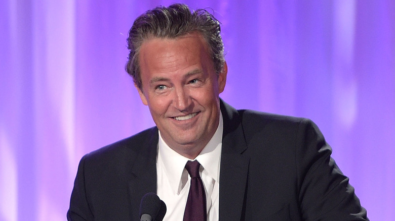 Matthew Perry smiling at a ceremony