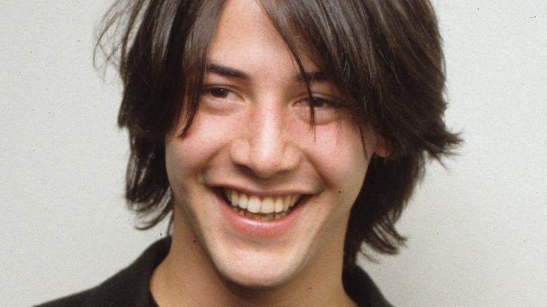 young Keanu Reeves smiling