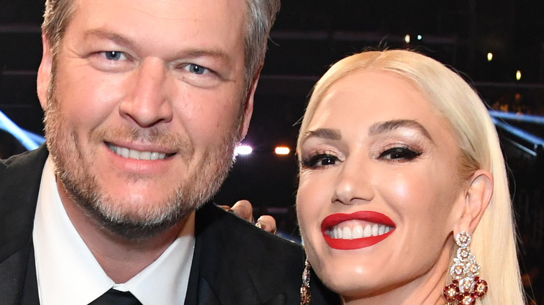 Gwen Stefani and Blake Shelton smiling at an event