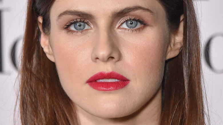 Alexandra Daddario poses with red lipstick