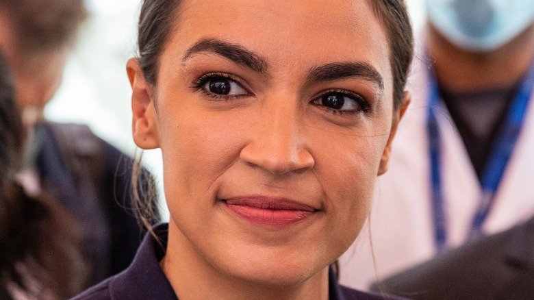 Alexandria Ocasio-Cortez smiling hair in ponytail